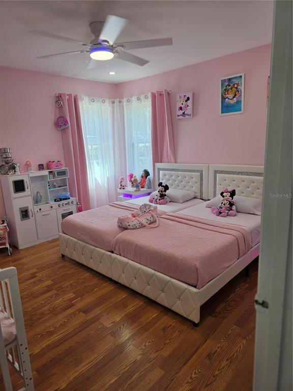 13128 Hazelcrest Street Spring Hill, FL 34609 - Photo 26 of 46 a bedroom with a bed and a flat screen tv