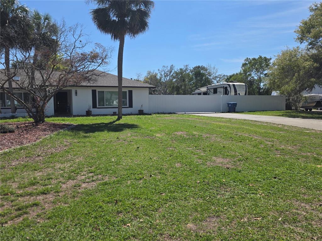 13128 Hazelcrest Street Spring Hill, FL 34609 - Photo 46 of 46 a view of a house with backyard and a tree