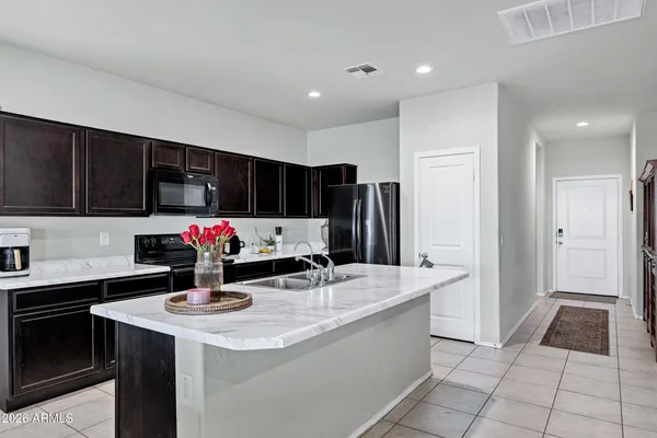 a kitchen with granite countertop a sink and cabinets