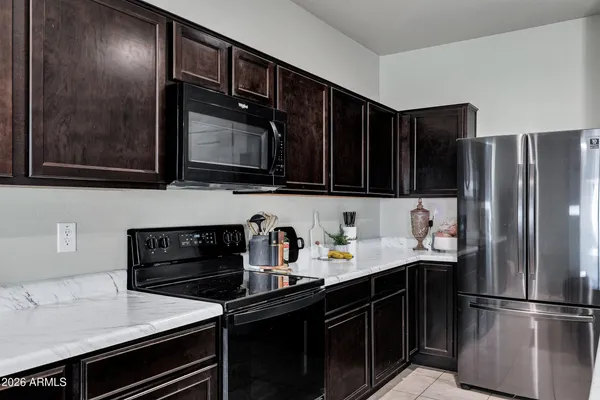 a kitchen with a refrigerator and a stove top oven
