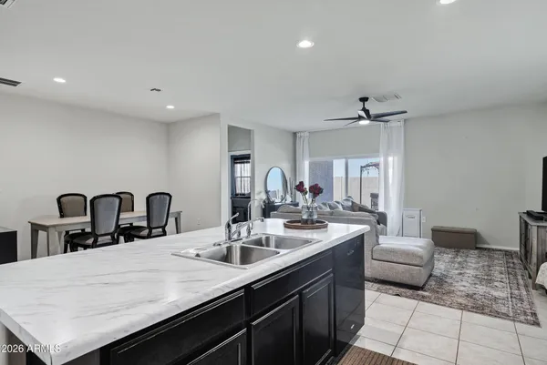 a kitchen with a sink dishwasher and a stove with wooden floor