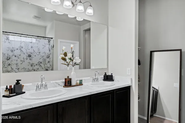 a bathroom with a double vanity sink and a mirror