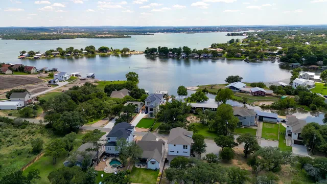 an aerial view of a houses with outdoor space and lake view