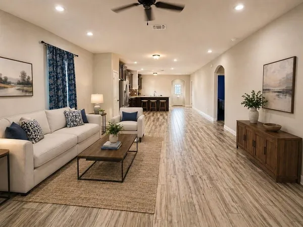 a living room with furniture and a wooden floor