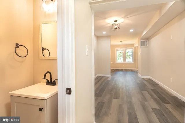 a bathroom with a sink and mirror with window