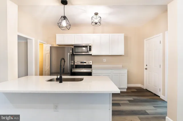a kitchen with sink cabinets and refrigerator