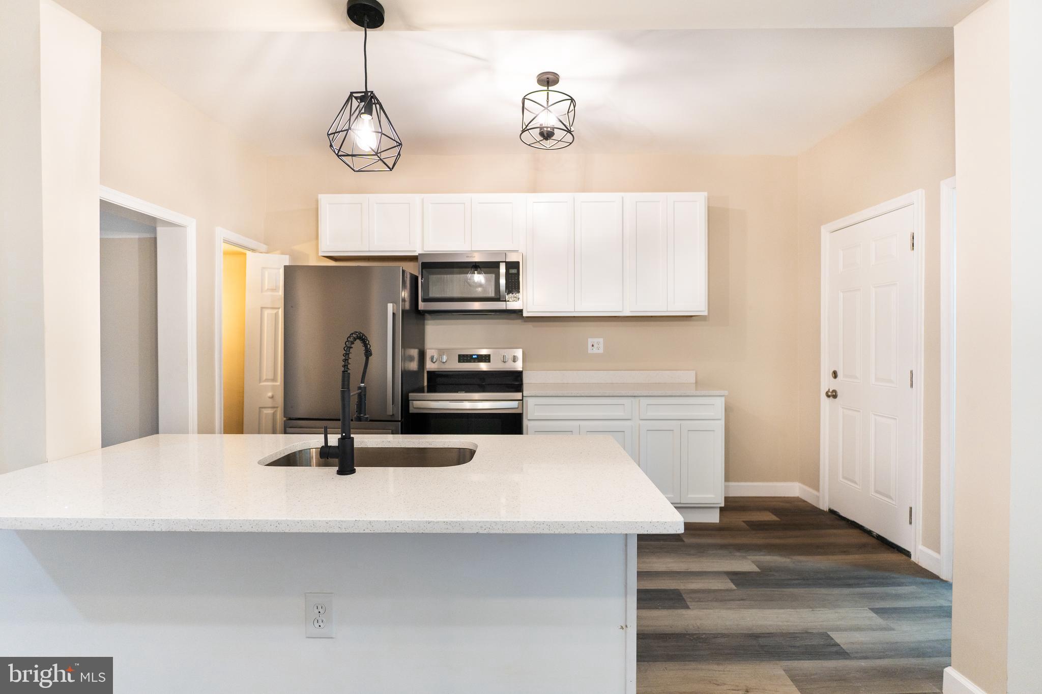 2808 Waldorf Avenue Baltimore, MD 21215 - Photo 14 of 26 a kitchen with sink cabinets and refrigerator