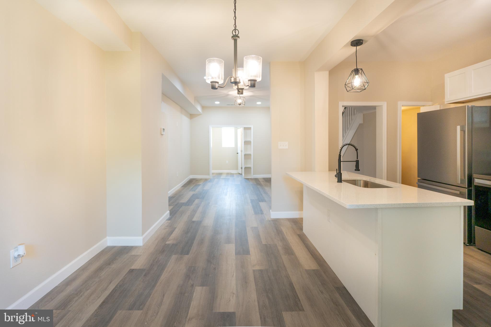 2808 Waldorf Avenue Baltimore, MD 21215 - Photo 15 of 26 a spacious bathroom with a double vanity sink a mirror and shower view