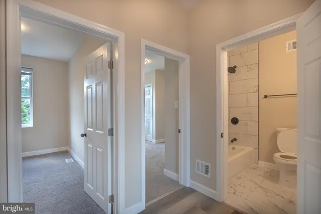 a view of a bathroom from a hallway