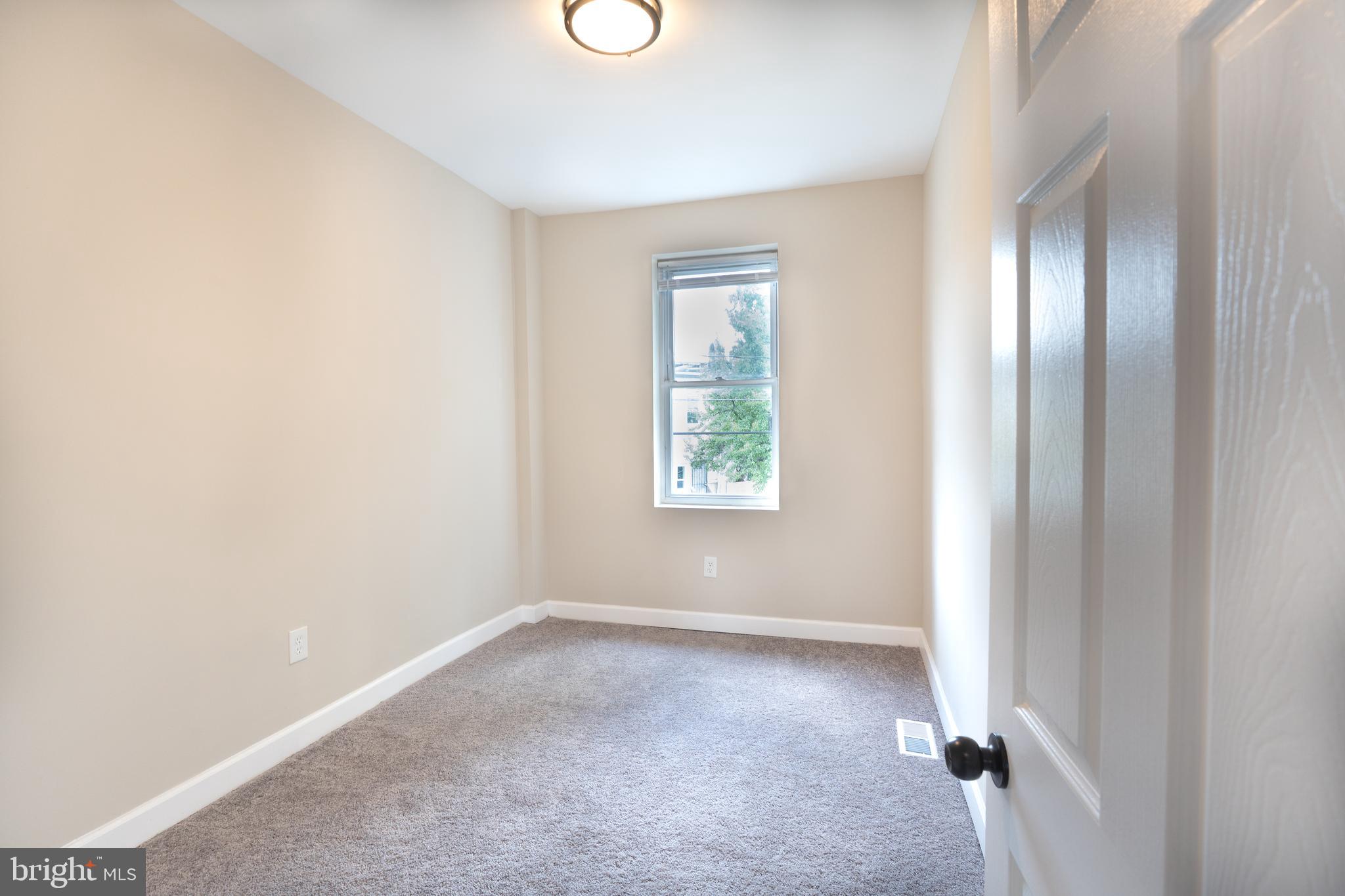 2808 Waldorf Avenue Baltimore, MD 21215 - Photo 22 of 26 an empty room with windows and closet