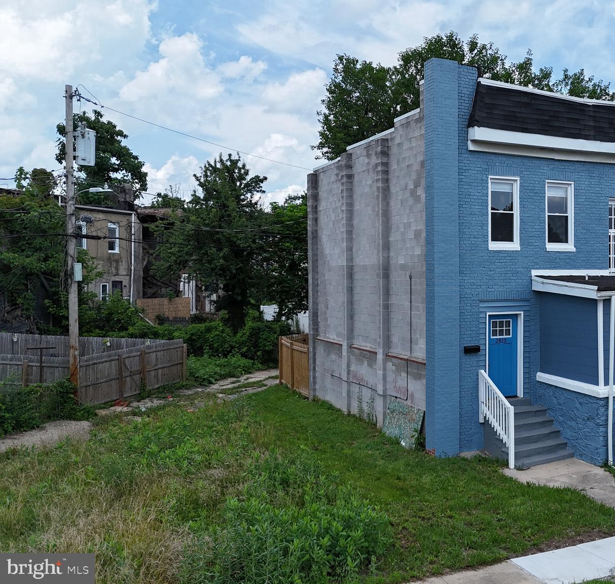 2808 Waldorf Avenue Baltimore, MD 21215 - Photo 4 of 26 a view of a house with brick walls and a fence