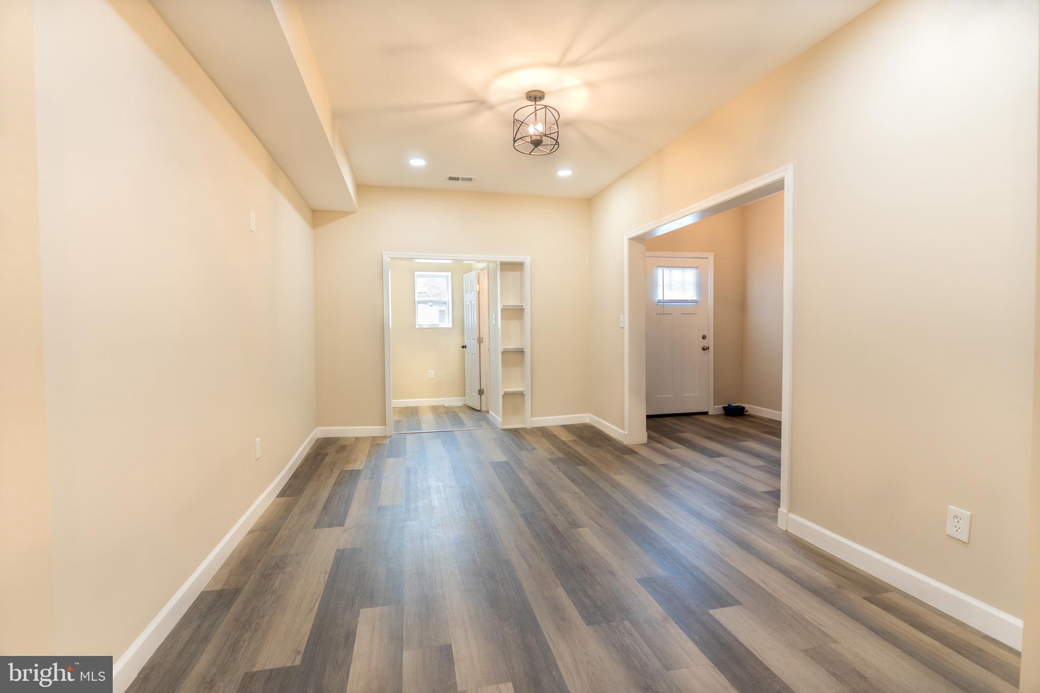 2808 Waldorf Avenue Baltimore, MD 21215 - Photo 10 of 26 wooden floor in an empty room with a window