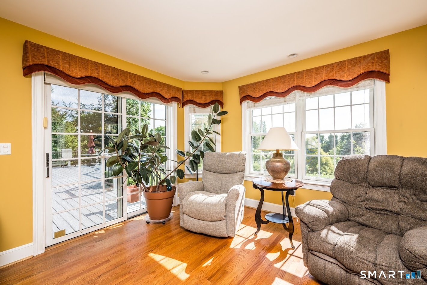 35 Anderson Lane Durham, CT 06422 - Photo 10 of 25 Sun-filled sitting area with hardwood floors, oversized windows, and sliding glass doors leading to the expansive Trex deck and beautifully landscaped backyard.