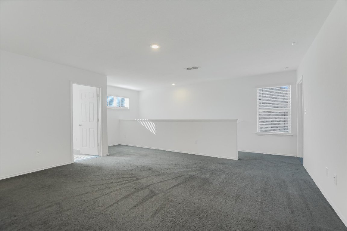 661 Pickrell Loop Georgetown, TX 78628 - Photo 11 of 27 an empty room with windows