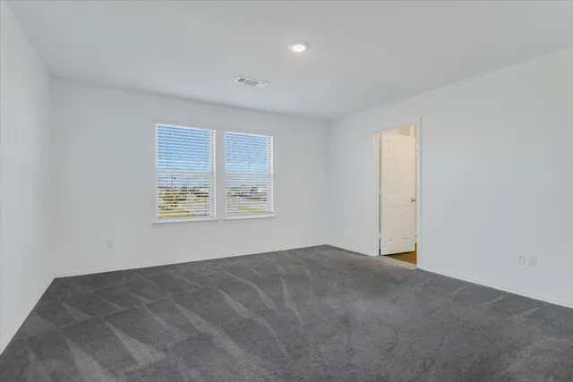 a bathroom view with a toilet and a shower