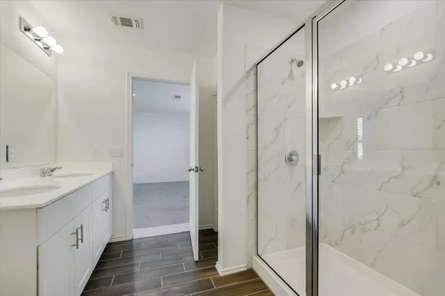 a bathroom with a sink toilet and shower
