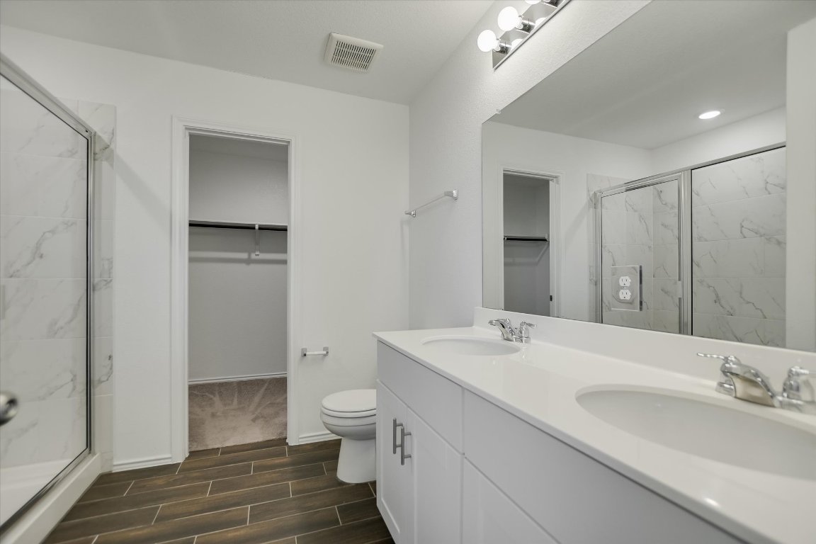 661 Pickrell Loop Georgetown, TX 78628 - Photo 16 of 27 a bathroom with a sink toilet and shower