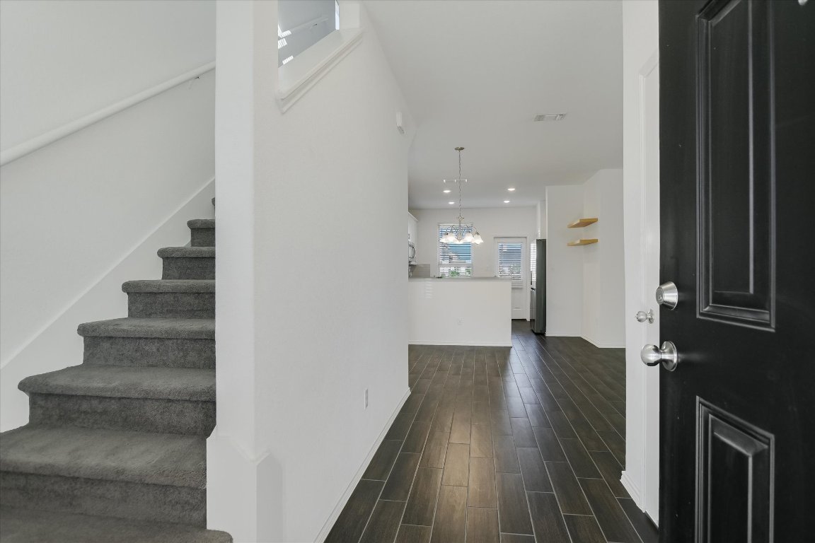 661 Pickrell Loop Georgetown, TX 78628 - Photo 4 of 27 a view of a hallway with wooden floor and staircase