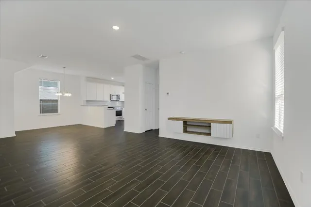 a view of a room with wooden floor and windows