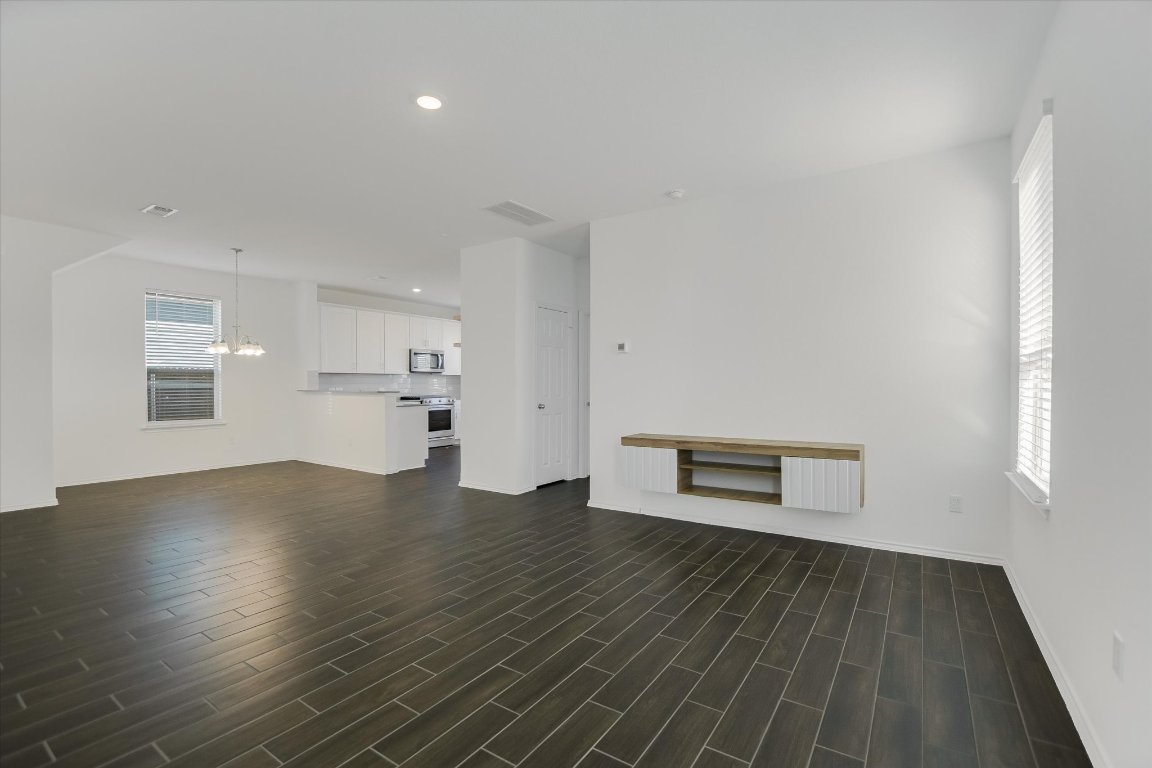 661 Pickrell Loop Georgetown, TX 78628 - Photo 6 of 27 a view of a room with wooden floor and windows