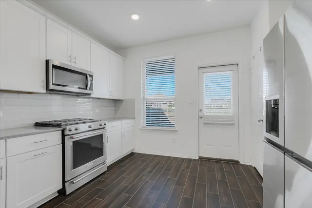 a kitchen with a stove microwave and sink