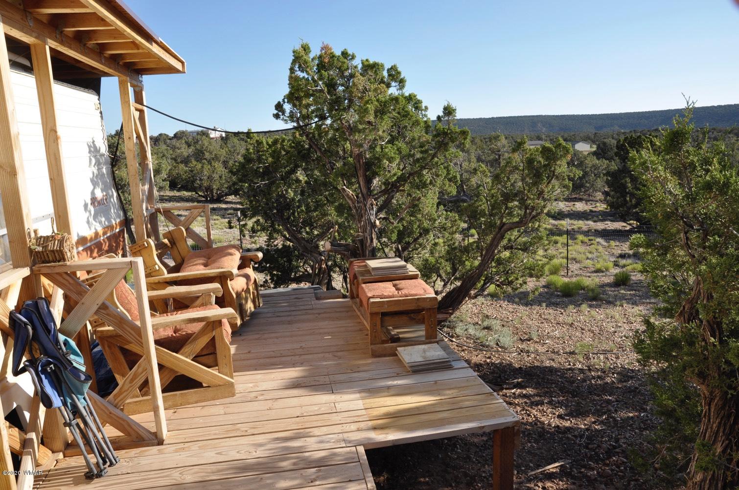 4241 Colt Road Snowflake, AZ 85937 - Photo 3 of 28 a view of a balcony with chairs and wooden floor
