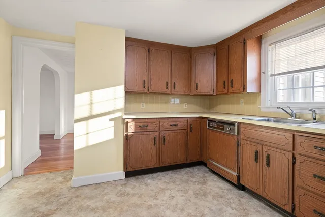 a kitchen with a refrigerator a stove a cabinets and a window