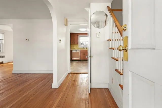 a view of a hallway view with wooden floor and entryway