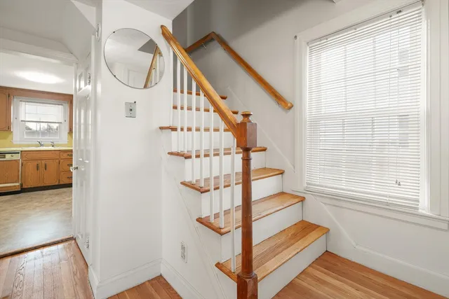 a view of staircase with white walls and windows