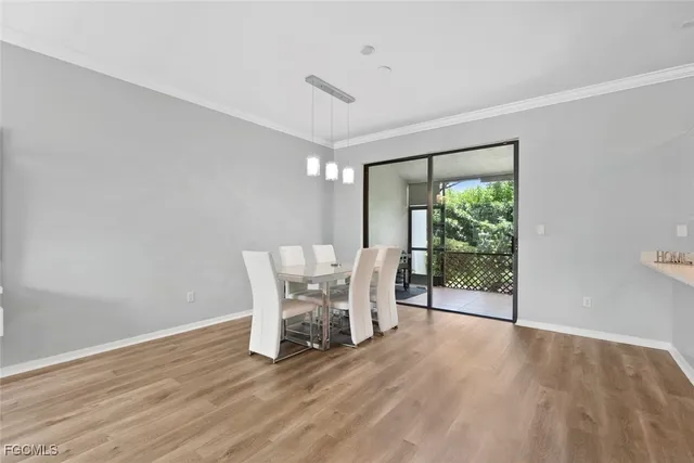 a view of a room with furniture and wooden floor
