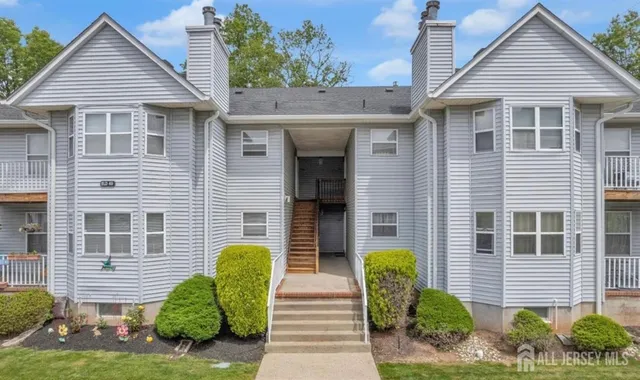 a view of a house with a chairs in a patio