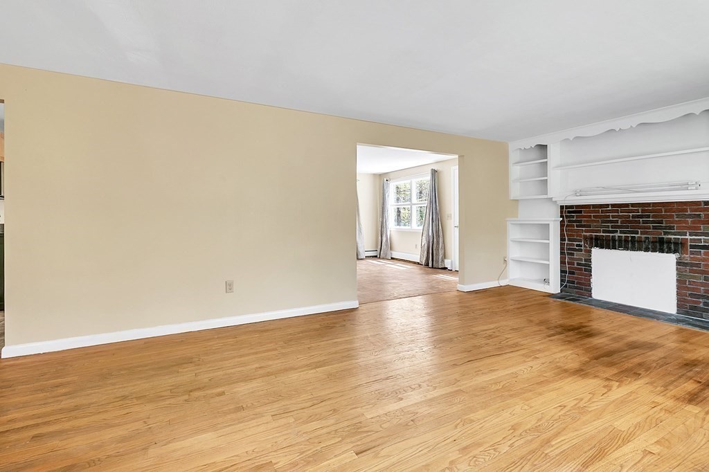 34 1/2 Paradise Lake Road Monson, MA 01057 - Photo 11 of 30 a view of empty room with wooden floor and fireplace