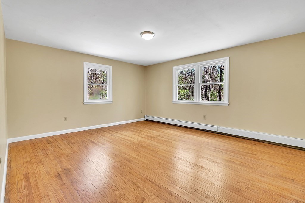 34 1/2 Paradise Lake Road Monson, MA 01057 - Photo 24 of 30 a view of an empty room with wooden floor and a window