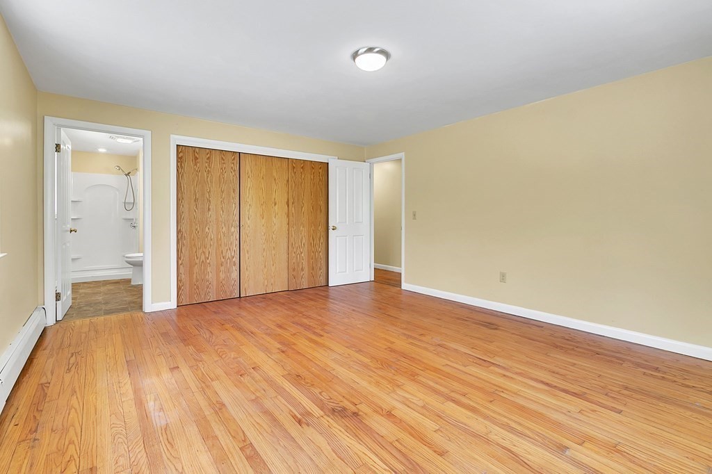 34 1/2 Paradise Lake Road Monson, MA 01057 - Photo 25 of 30 an empty room with wooden floor and windows
