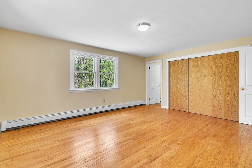34 1/2 Paradise Lake Road Monson, MA 01057 - Photo 26 of 30 an empty room with wooden floor and windows