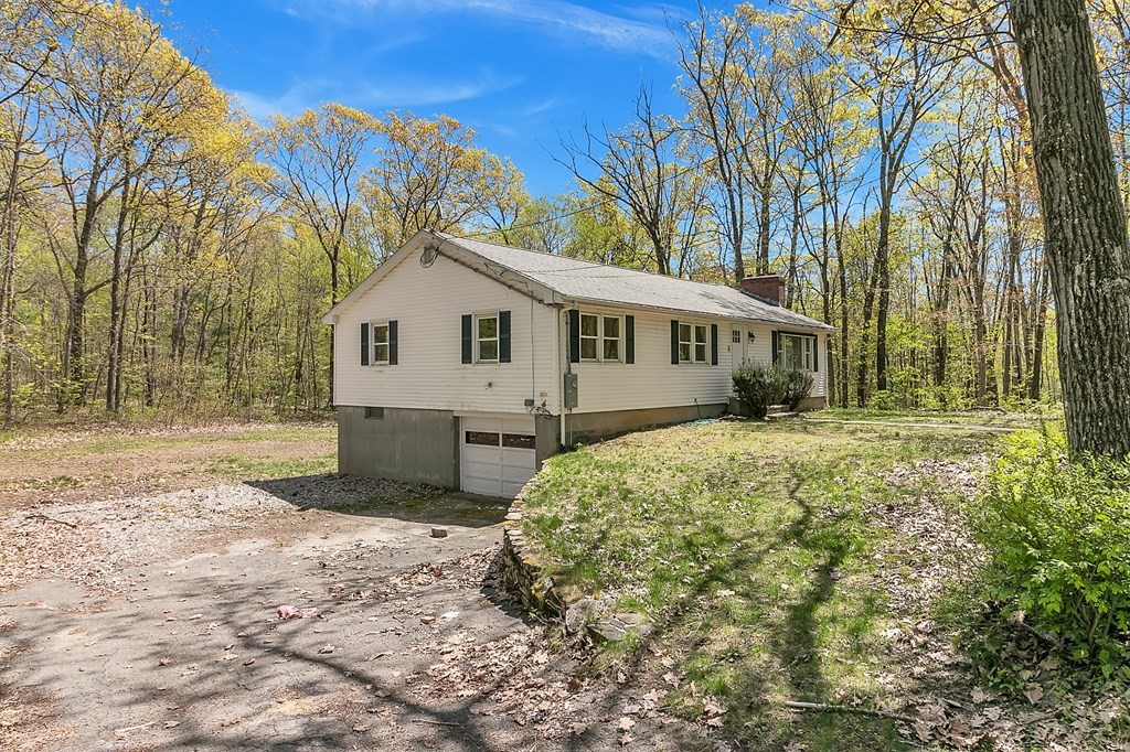 34 1/2 Paradise Lake Road Monson, MA 01057 - Photo 3 of 30 a view of a white house with a large tree and yard