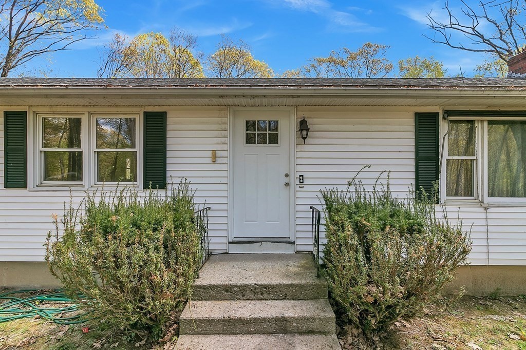 34 1/2 Paradise Lake Road Monson, MA 01057 - Photo 5 of 30 a view of a house with a window and flower plants
