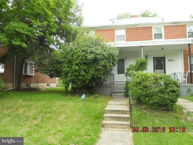 3922 Clarinth Road Baltimore, MD 21215 - Photo 1 of 10 a front view of a house with a yard and trees