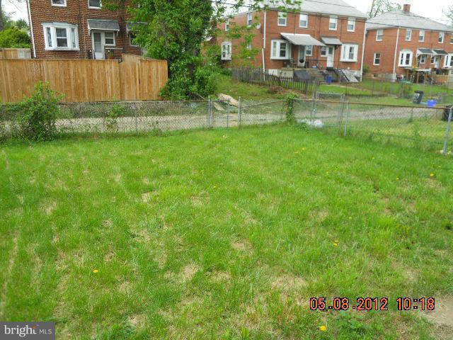 3922 Clarinth Road Baltimore, MD 21215 - Photo 2 of 10 a garden view with a building in the background
