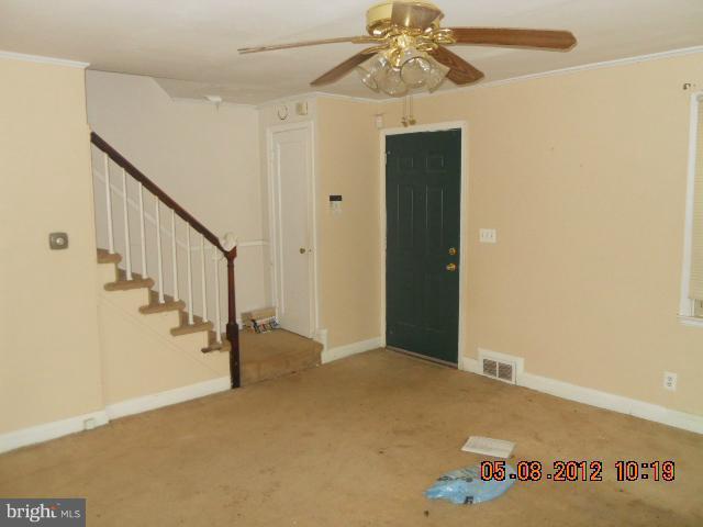 3922 Clarinth Road Baltimore, MD 21215 - Photo 4 of 10 a view of an empty room with wooden floor