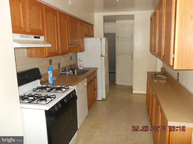 3922 Clarinth Road Baltimore, MD 21215 - Photo 6 of 10 a kitchen with stainless steel appliances granite countertop a refrigerator stove top oven and sink