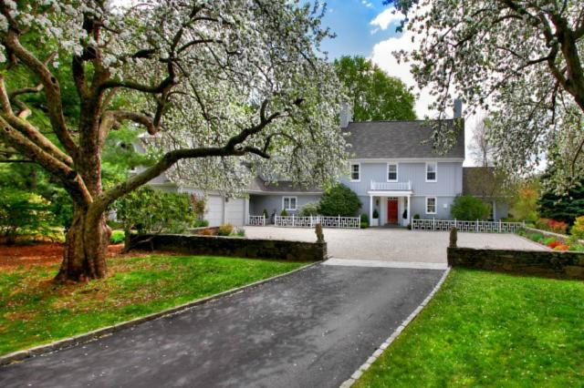 201 Old Academy Road Fairfield, CT 06824 - Photo 1 of 1 a front view of a house with a garden and tree