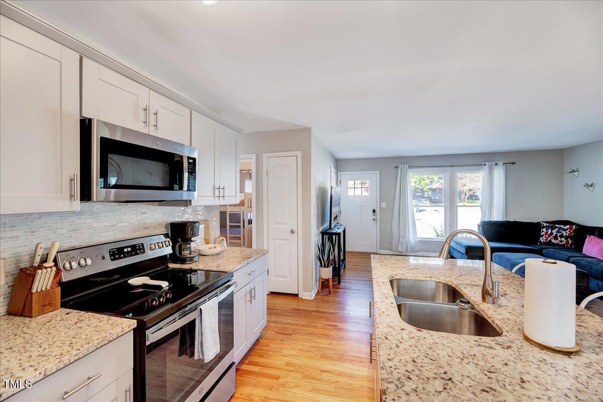 2809 Newark Drive Raleigh, NC 27610 - Photo 11 of 36 a kitchen with stainless steel appliances granite countertop a sink stove and refrigerator