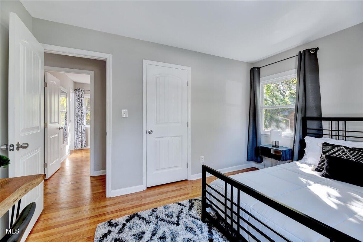 2809 Newark Drive Raleigh, NC 27610 - Photo 17 of 36 a bedroom with a bed and wooden floor