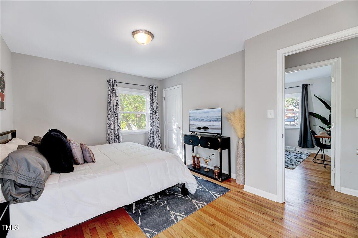 2809 Newark Drive Raleigh, NC 27610 - Photo 21 of 36 a bedroom with a bed and wooden floor