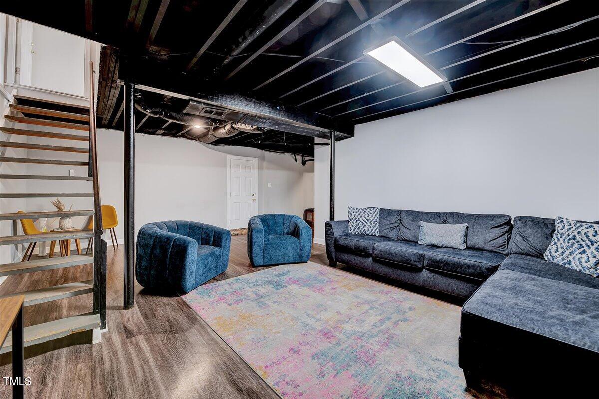 2809 Newark Drive Raleigh, NC 27610 - Photo 23 of 36 a living room with furniture and a wooden floor