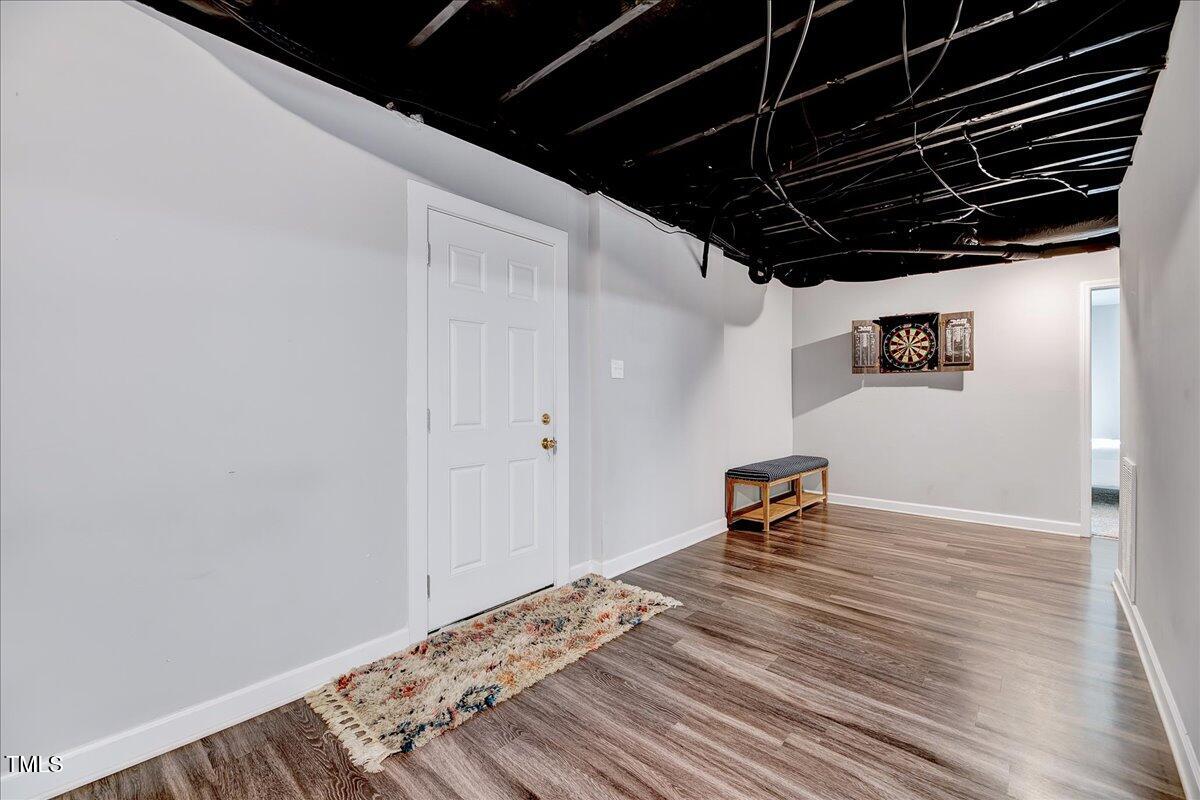 2809 Newark Drive Raleigh, NC 27610 - Photo 25 of 36 a view of a room with wooden floor