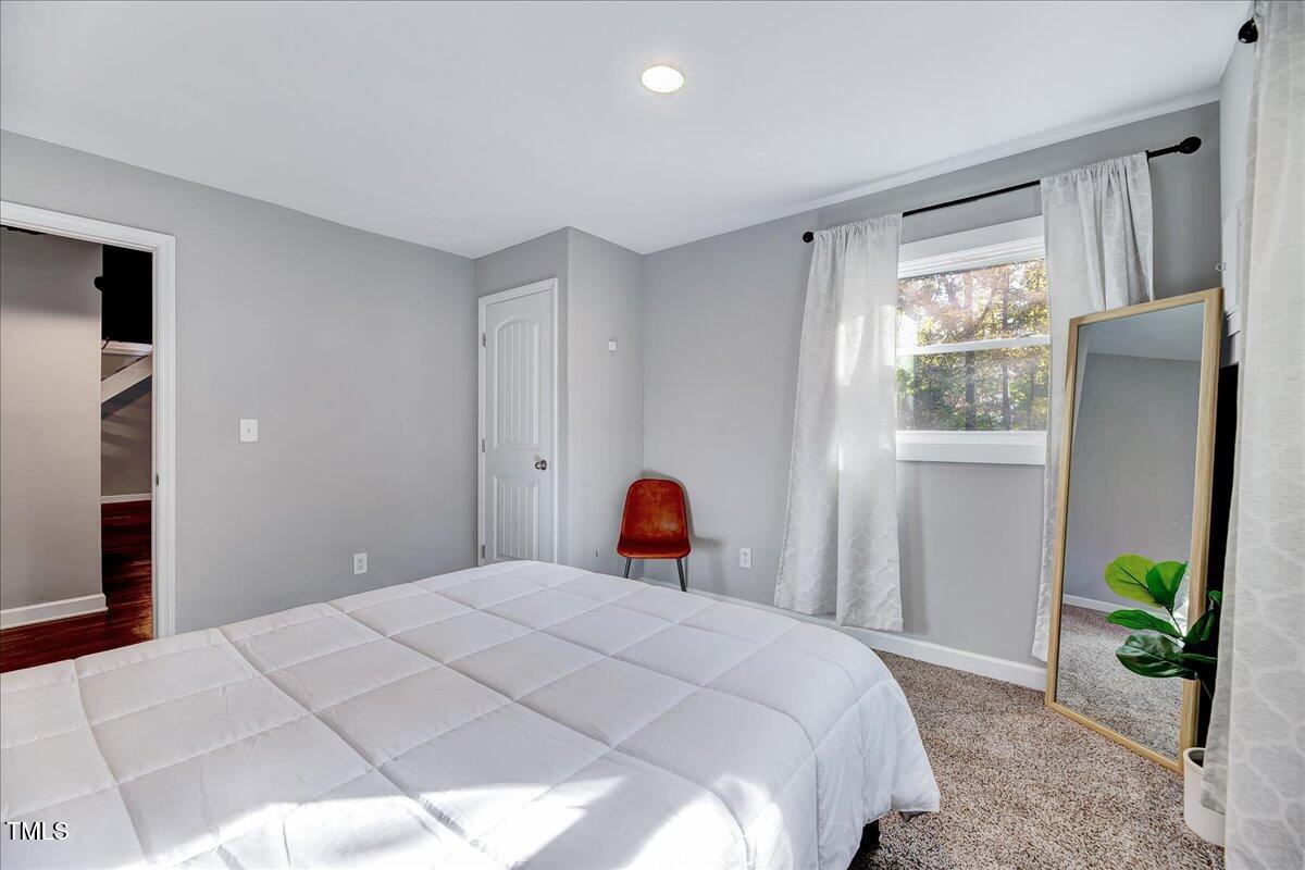 2809 Newark Drive Raleigh, NC 27610 - Photo 28 of 36 a bedroom with a bed and a window