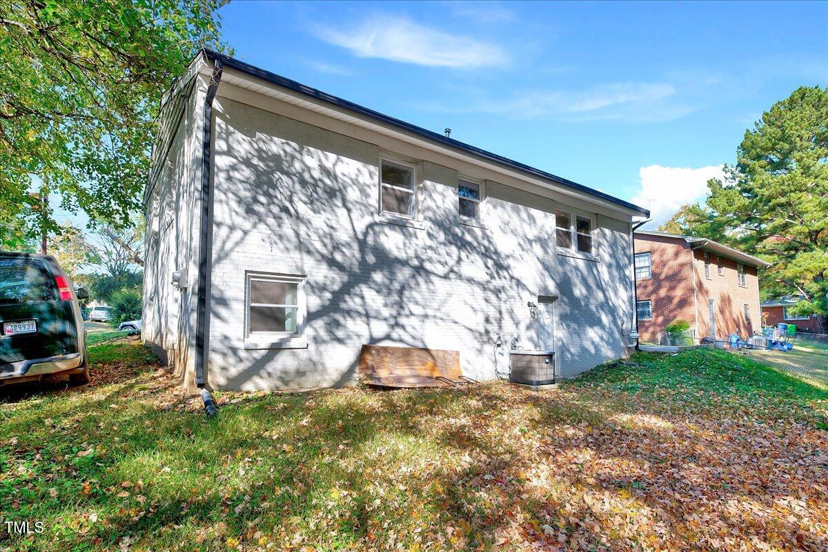 2809 Newark Drive Raleigh, NC 27610 - Photo 33 of 36 a backyard of a house with plants and large tree