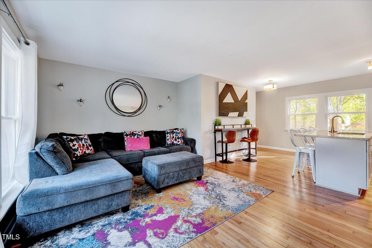 2809 Newark Drive Raleigh, NC 27610 - Photo 4 of 36 a living room with furniture and wooden floor
